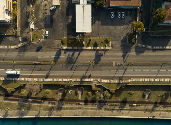 A breathtaking aerial view of İzmir's coastal road and waterfront, basking in the golden glow of sunset.